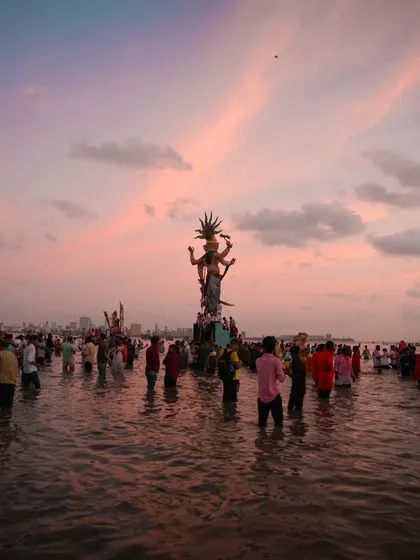 Capturing the final moments of the Ganesh Visarjan at sunset. This shot is all about the scale, the devotion, and the beautiful, bittersweet feeling as the sky turns pink over the Arabian Sea.