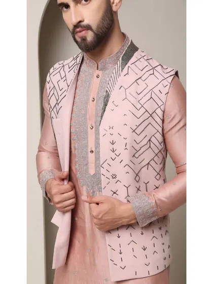 A close-up of the Mystic Rose bandi set, showing the intricate geometric embroidery on the jacket and the rich texture of the rose copper kurta.