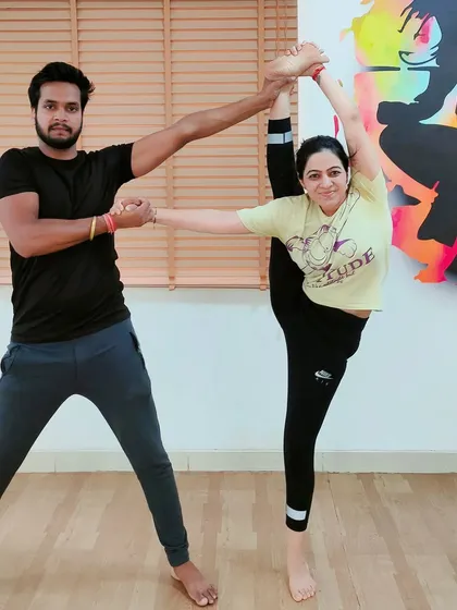 Working together on an advanced standing split. My role is to provide balance and support, allowing the student to safely explore the limits of her flexibility.