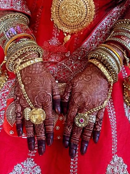 The stunning bridal mehndi for Saqlain's bride, complete with her full bridal attire and jewelry. The rich stain looks incredible.