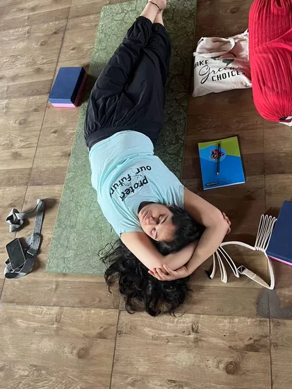 A student in a supported twist, demonstrating the deep relaxation and release that is central to the practice of Yin yoga.