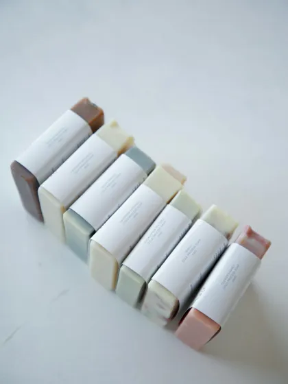 Another view of the assorted soaps, showcasing their simple and elegant packaging.