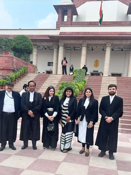 Posing with fellow advocates outside the Supreme Court of India. These moments capture the spirit of our profession.