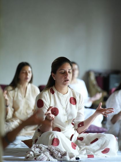 A student chanting during a workshop, her hands open to receive. The energy of the group amplifies our individual experiences.