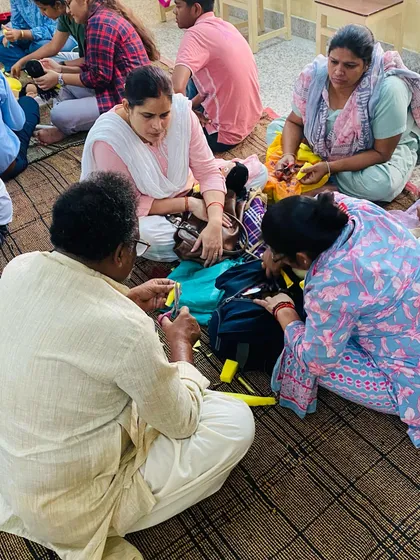 I always sit with my students to help them directly. Here, I am showing a group of teachers the technique for making a simple hand puppet.