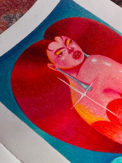 A close-up of a colored pencil drawing, showing a face inside a heart shape.