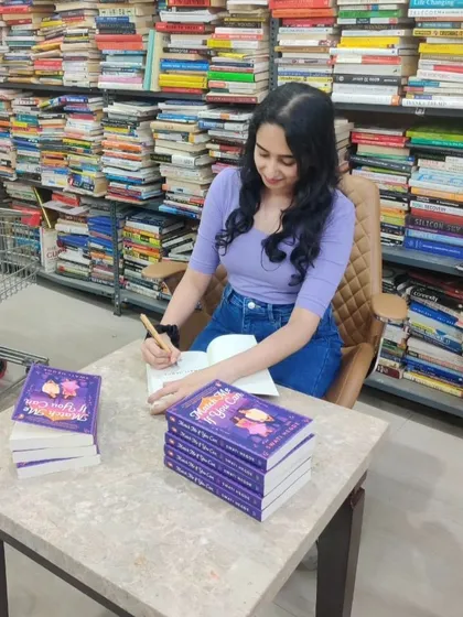 Signing books at a bookstore surrounded by stacks of books. This is the dream. I'm so grateful for every opportunity to connect with the reading community.