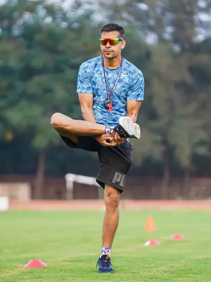 The process is everything. A moment of demonstration during a dynamic warm-up, focusing on hip mobility.