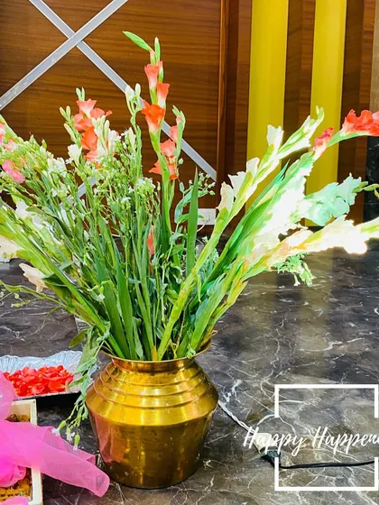 We use fresh, vibrant flowers to bring life to our setups. This close-up shows a traditional brass vase filled with beautiful gladiolus and tuberose, a simple yet elegant detail that adds fragrance and grace to the decor.