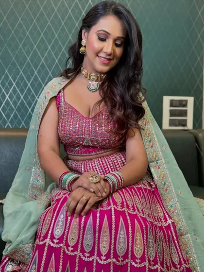 The complete bridal look. Her hair is styled in soft, cascading waves, and the makeup is perfectly balanced to enhance her features without feeling heavy, letting her feel comfortable and confident.