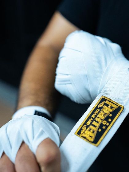 Wrapping the hands is a fundamental skill for any boxer or Muay Thai fighter. It protects the knuckles and wrists, allowing you to punch with full power safely.