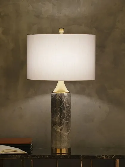 We celebrate timeless materials in our designs. This table lamp features a solid pillar of mid-century modern marble, bringing a sense of natural luxury and grounded sophistication to your side table or console.