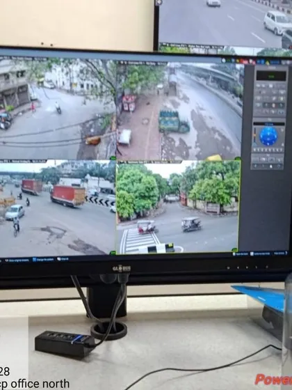 A clear daytime feed from a four-camera setup overlooking a traffic junction. The system captures important details like vehicle movement and road conditions.