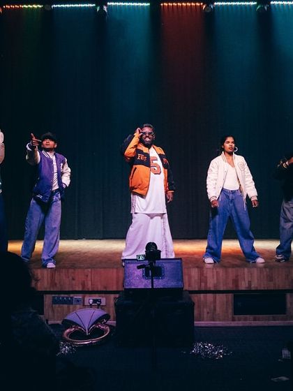 A wider view of our instructors' performance, showcasing their powerful stage presence and the dynamic choreography that inspires our students.