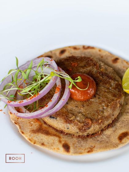 Another fusion dish from our Awadhi pop-up: a Roghni Taco filled with traditional Shami Kebab, served with onions and a tangy chutney.