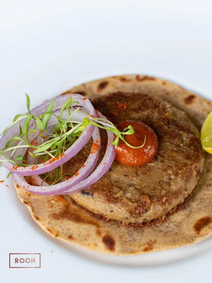 The textures of the soft kebab and the crisp taco, topped with fresh onions and microgreens, create a delightful bite. I love to play with contrasts in my dishes.