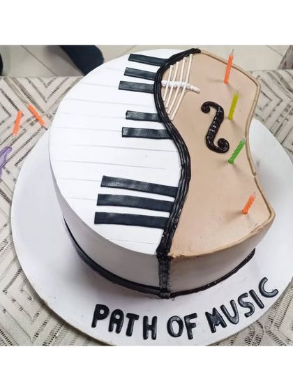 A special cake celebrating our Annual Fest, designed like a piano and violin. These celebrations are a cherished tradition that brings our entire musical family together.
