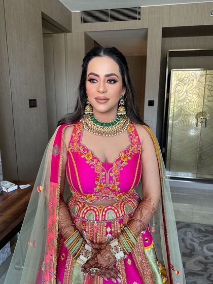 A front view of the bride with her whimsical butterfly and floral hairstyle, looking ready for her Mehendi party.