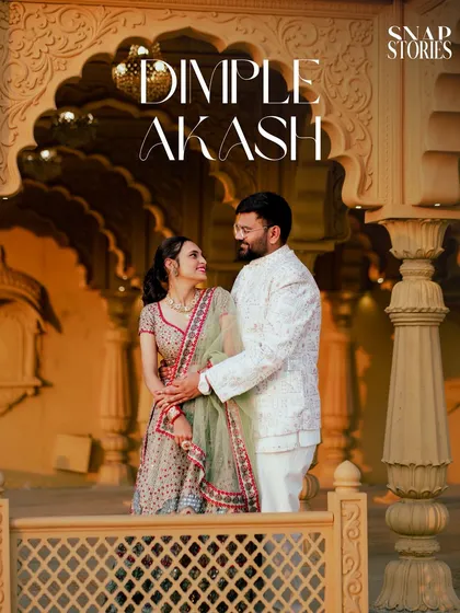 A close-up, candid moment between the couple, framed by the intricate details of a heritage palace wall. This captures the romance of a royal-themed shoot.