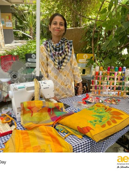 A local tailor offers her services on campus for Earth Day. By bringing in community craftspeople, we highlight the value of traditional skills in promoting sustainability.