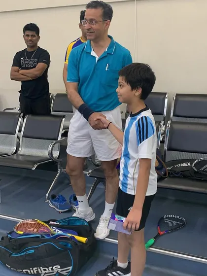 A moment of sportsmanship at the Willingdon Squash Academy tournament, as a young player receives his prize.