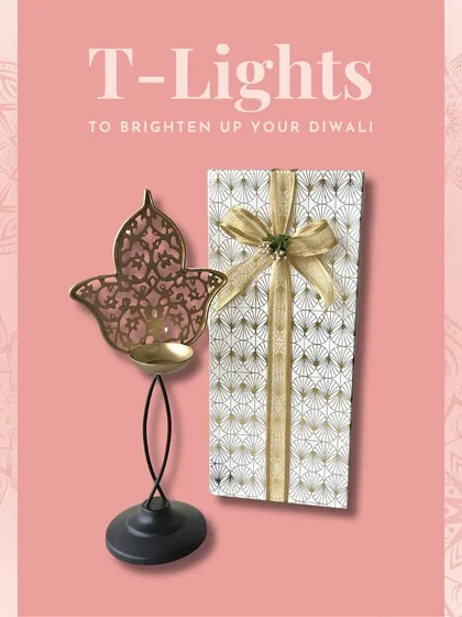 A tall, elegant Hamsa-shaped T-light holder, beautifully packaged for gifting. This piece adds height and drama to any decorative arrangement.