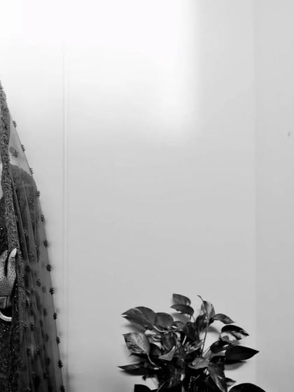 A timeless black and white bridal portrait. This style emphasizes the bride's expression and the classic beauty of her look, free from the distraction of color.