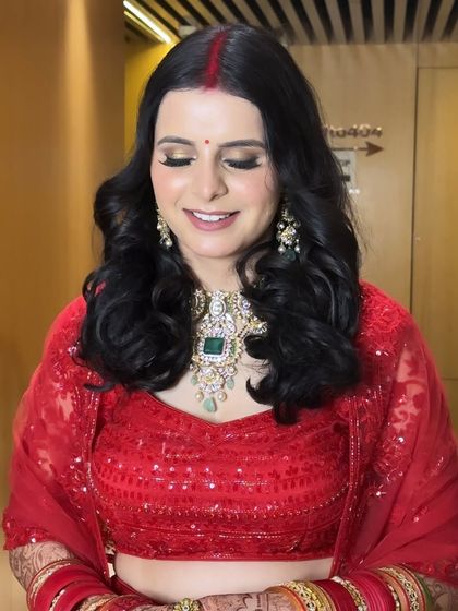 A close-up of this beautiful reception makeup. The soft gold shimmer on the eyes and the flawless base create a radiant glow that perfectly complements her emerald jewelry.