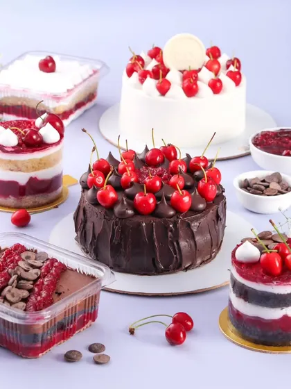 Our fresh cherry menu is perfect for the monsoon season. This spread shows our full range, including a chocolate cherry cake, a vanilla cherry cake, mini cherry desserts, and our popular cherry dessert tubs.