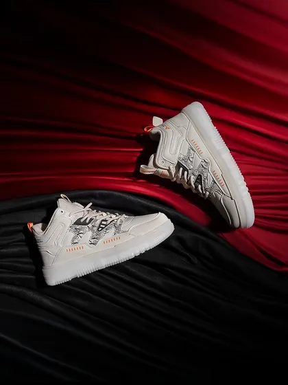 A luxurious shot of white sneakers on a bed of red and black satin. The rich textures and colors elevate the product, making it feel premium and exclusive.