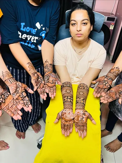 The mom-to-be with her friends and family, all showing off their mehndi from our team. We love being part of group celebrations.