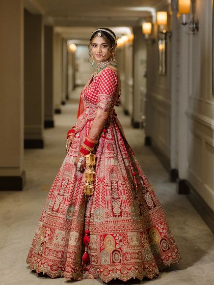 A full-length portrait of the bride in the corridor, showcasing her stunning wedding attire from head to toe.