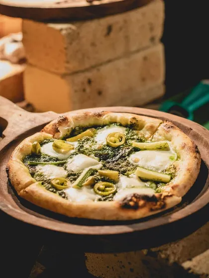 A freshly baked pesto and mozzarella pizza from one of our live stations. We bring the authentic taste of wood fired pizza to events across the country and the world.