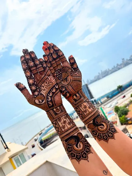 A minimal bridal design with a stunning view. The focus is on the elephant and peacock motifs against the backdrop of the Mumbai skyline.