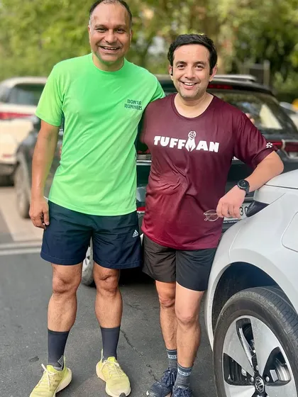 Two members, one in a Tuffman tee, posing after a weekend run. We often wear our race gear to regular runs, sharing stories of past events.