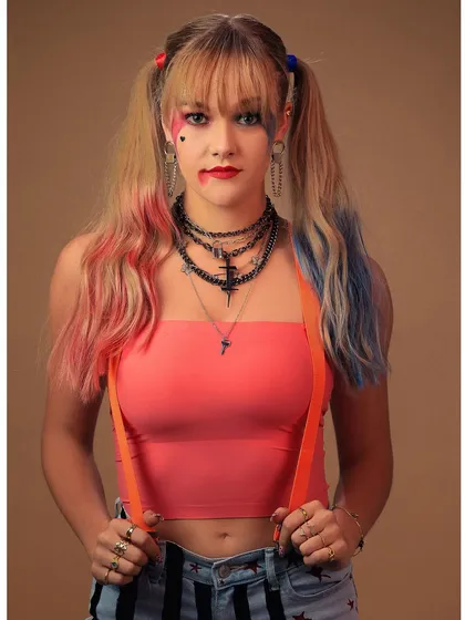 A mid-shot of the Harley Quinn cosplay, capturing the full attitude with the iconic suspenders and layered necklaces.