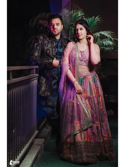 A full-length portrait of siblings Vipul and Vanshika posing together during the pre-wedding religious ceremony.