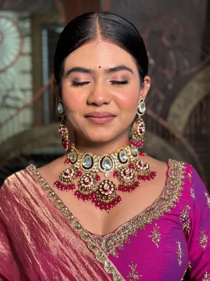 An eyes-closed shot focusing on the soft, shimmery eye makeup.