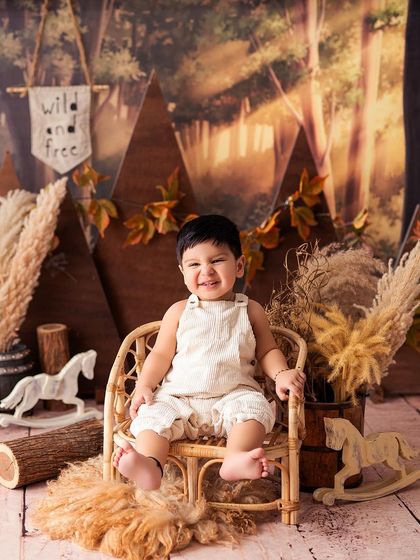 A big, happy smile from this little adventurer. The warm, earthy tones of the woodland set create a cozy and inviting atmosphere.