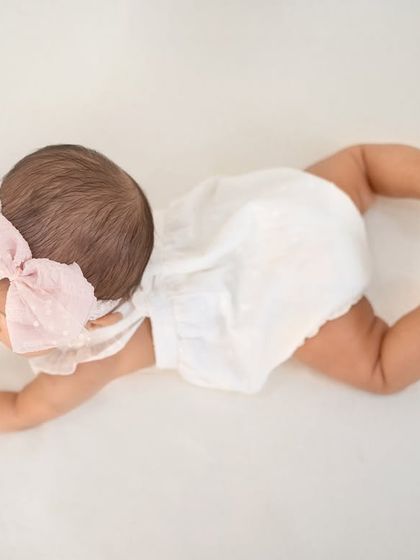 The beginning of a crawl. This shot captures the effort and determination of a baby learning to move, a huge milestone in their first year.