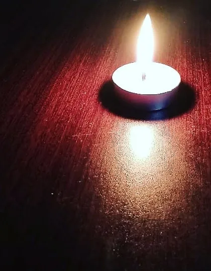 A single handmade tealight candle casting a warm, steady glow. These are essential for creating ambiance and are guaranteed to burn for at least 1.5 to 2 hours.