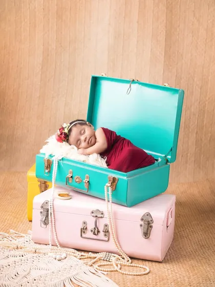 This little traveler is sleeping soundly in a vintage-style trunk. I love using creative props like these to tell a unique story for your baby.