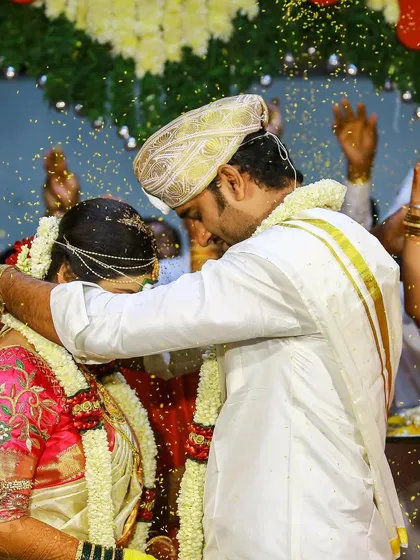 The joyous shower of blessings during a traditional South Indian wedding ceremony. We focus on capturing the energy and key rituals that make your wedding day unforgettable.