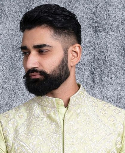 A close portrait in the mint green bundi, showing the detailed embroidery on the collar.