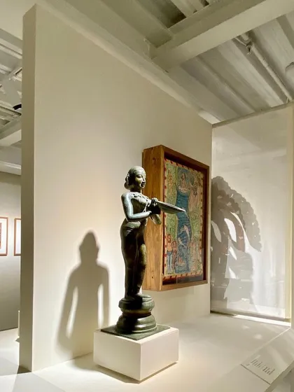 A sculpture on display within a niche at the Museum of Art and Photography (MAP). The architecture provides a variety of spaces, from large open galleries to more intimate corners, to suit artworks of different scales and characters.