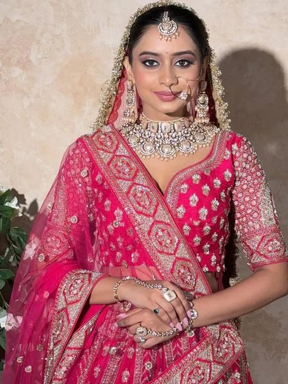 A beautiful bride in our vibrant pink lehenga. This piece features delicate silver embroidery and a flattering neckline, making it a fresh and modern choice for the contemporary bride.