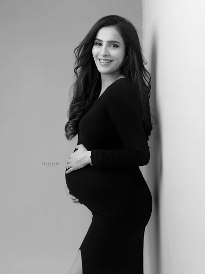 A simple, elegant portrait against a wall. Black and white gives this classic pose a timeless, documentary-style feel.