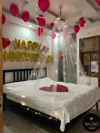 A clear shot of the anniversary bed decoration, highlighting the delicate canopy and the petal heart.