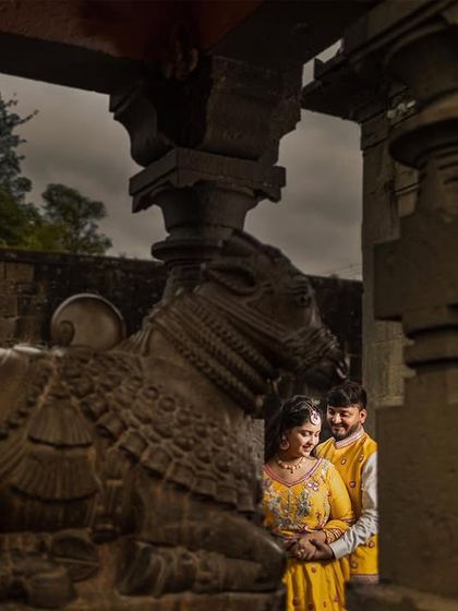 A quiet moment of connection within the hallowed walls of an ancient temple. The stone pillars and historic sculptures provide a timeless and soulful backdrop for this couple's portrait.