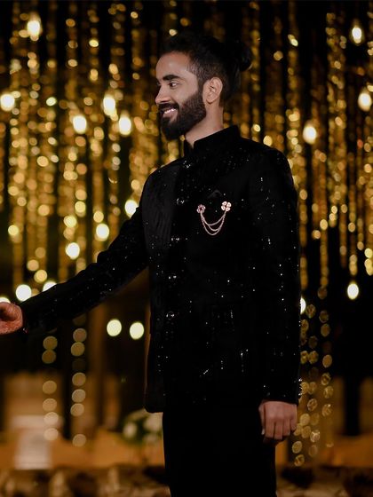 A portrait of the groom looking dapper against a backdrop of beautiful bokeh lights during his engagement in Orchha. It's a stylish shot that captures his personality.